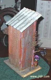 Back view of the birdhouse outhouse