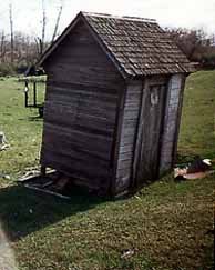 Side View of the Rooster-Doored Outhouse
