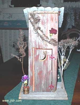 Front view of the birdhouse outhouse