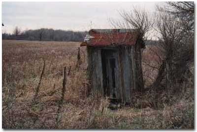 An Outhouse with a Beveled Window