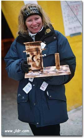 Sherry holding the 2001 Outhouse Classic Trophy