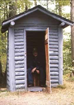 The Proud Owner of the Log Outhouse