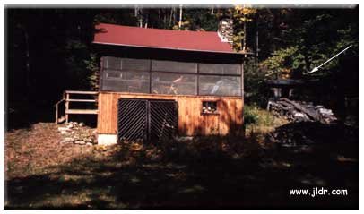 The cabin with the outhouse at the right