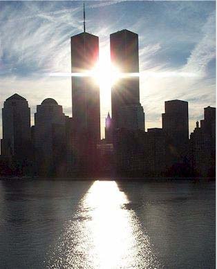 This picture was taken by a lady returning on a cruise this past summer. SHE Writes: As I watched the beautiful skyline of New York City float past me I noticed the sun was about to line up just behind the twin towers. I was lucky enough to snap the picture at exactly the right moment. If you look at the sun rays it is almost prophetic - a little spooky. 